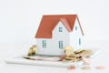 House ownership concept Ã¢â¬â a model house on a pile of coins Royalty Free Stock Photo